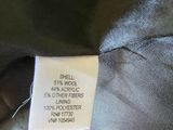 the label of a black jacket is on the back of the jacket