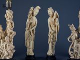 four carved ivory figurines of asian women and men