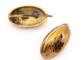 two pieces of jewelry that are on a white surface