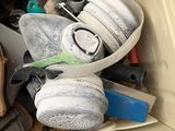 a pile of shoes and other items in a box