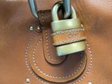a close up of a purse with a padlock on it