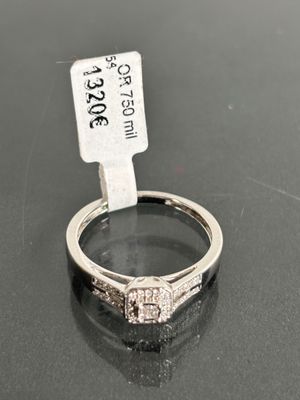 a close up of a diamond ring on a table with a price tag