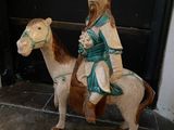 a statue of a man riding a horse next to a door
