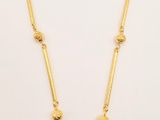 the necklace is made of gold and multi colored stones