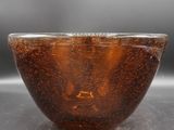 a glass bowl with a liquid inside of it on a table