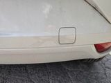 a close up of a car ' s rear end with the door open