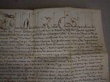 an old book with writing on it sitting on top of a table
