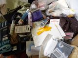 a pile of items that is sitting on a bed