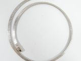 a silver necklace on a white table with a white background