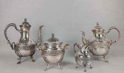 four pieces of silver tea and coffee set on a table