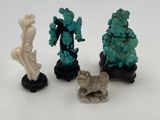 three figurines of a woman and a man on a white surface