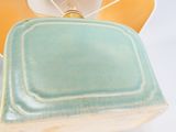 a blue and green square shaped dish on a white plate