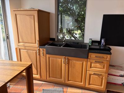 a kitchen with wooden cabinets and a black sink