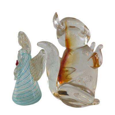 two glass figurines of angels sitting next to each other