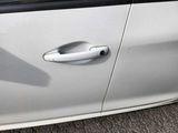 a close up of a door handle on a white car