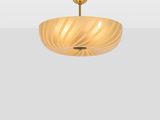 a close up of a light fixture on a white wall