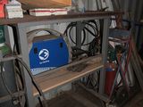 a metal shelf with a blue box on top of it