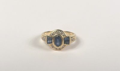 a gold ring with a blue sapphire stone and diamonds