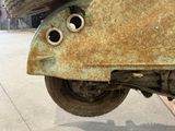 a rusted motor scooter with two eyes on it