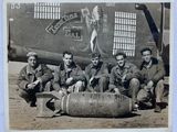 black and white photo of a group of men in front of an airplane