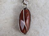 a close up of a pendant with a stone in it