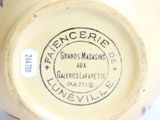 a close up of a yellow vase with a label on it