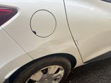 a white car that has a hole in the side of it