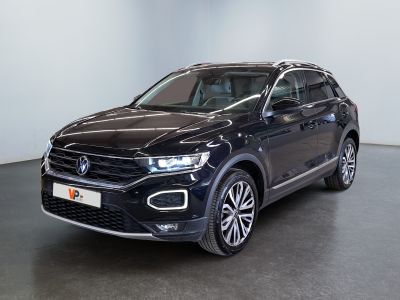 a black volkswagen suv parked in a large room