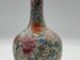 a vase with a floral design on it sitting on a table