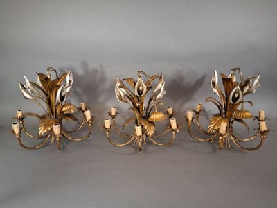 three antique brass wall sconces with flowers and leaves on them