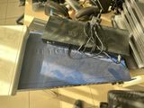 a laptop computer sitting on top of a desk with headphones on