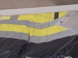 a yellow and black sleeping bag wrapped in plastic