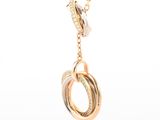 a close up of a gold necklace with a knot on it
