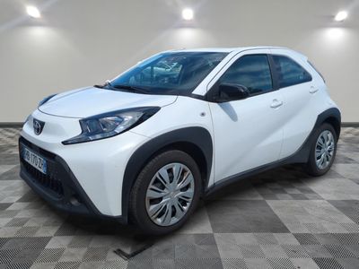 a white toyota c - hr parked on a checkered floor