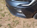 a close up of a car ' s headlight and front bumper