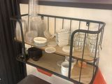 a shelf with dishes and cups on it in a room