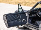 a car with the door open on the side of the road
