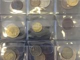 many different types of coins in the bins