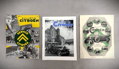 three old car brochures are displayed on a gray surface