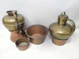 three pots and two cups sitting on a white surface