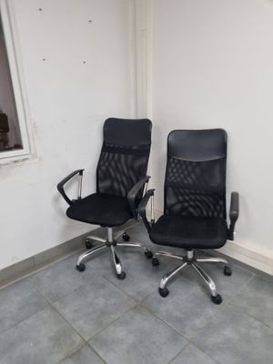 deux chaises de bureau noires placées l'une à côté de l'autre dans une pièce