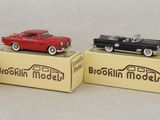 four toy cars are sitting on top of boxes with a sign on them