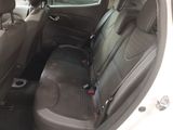the back seats of a white car with a black seat belt