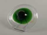 a close up of a glass with a green liquid inside of it