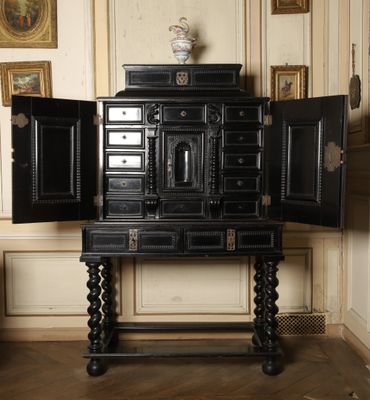 a black cabinet with a mirror on top of it