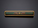 a gold and enamel bar with a design of flowers and leaves