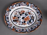 a plate with an orange and black floral design on it