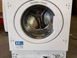 an image of a white washing machine sitting in a room