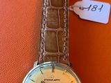 an image of a wrist watch on an orange surface with a price tag