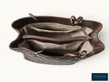 the inside of a brown purse with two zippers on it
